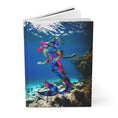 Load image into Gallery viewer, Detailed view of the matte cover of a journal depicting a handmade resin mermaid on wood, set against a beautiful ocean water background.
