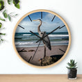 Load image into Gallery viewer, Close-up view of a wall clock with a heron design, showcasing the handmade resin on wood details that enhance its unique character.