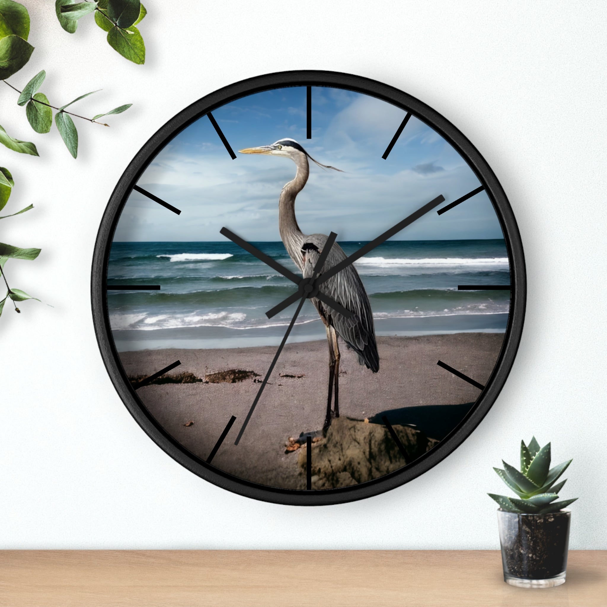 A stunning wall clock featuring a beautiful heron, made with handmade resin on wood, set against a calming ocean backdrop.