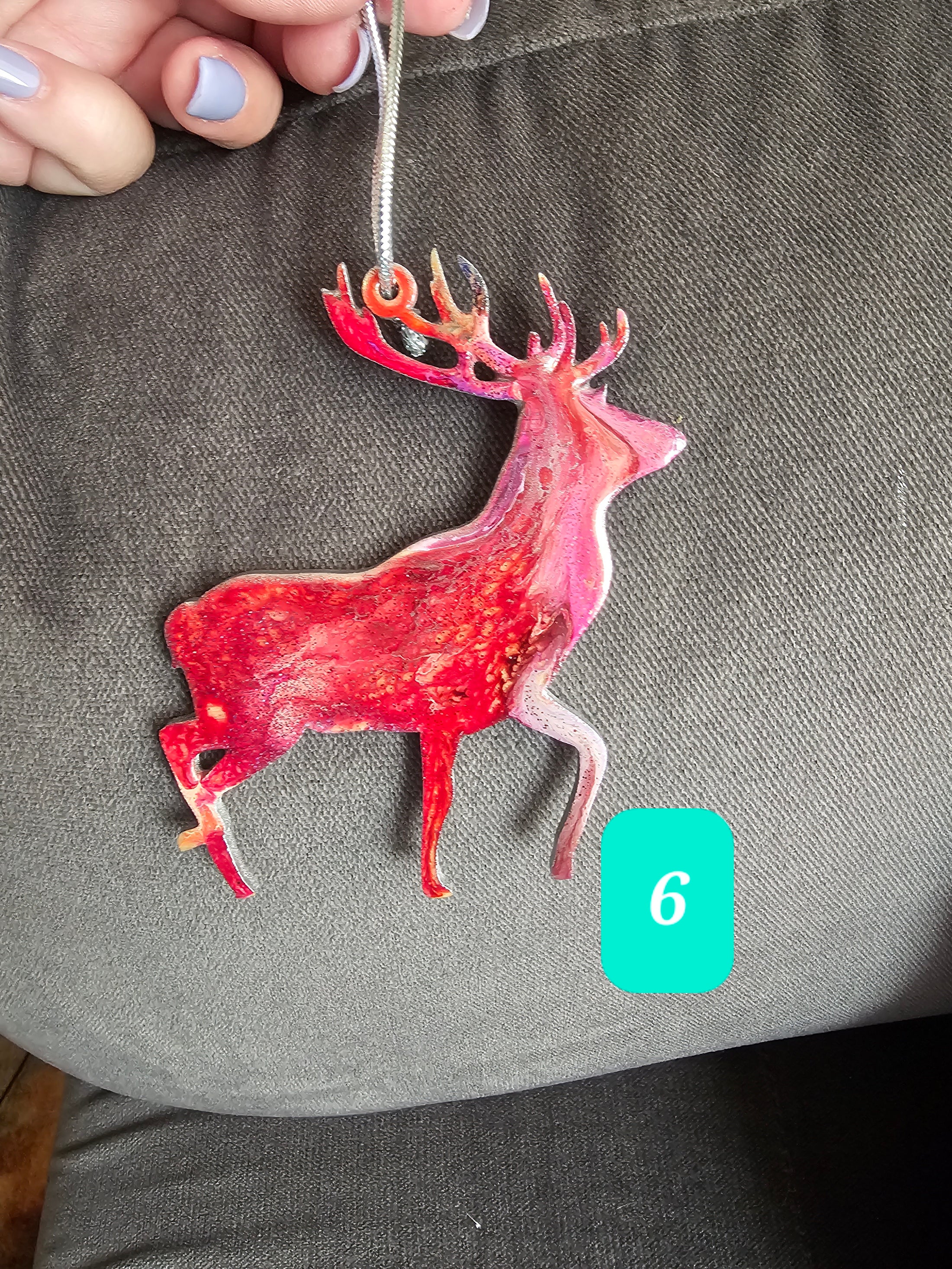 Artistic handmade resin on wood reindeer ornament, displaying one-of-a-kind colors and back painted for a polished finish.