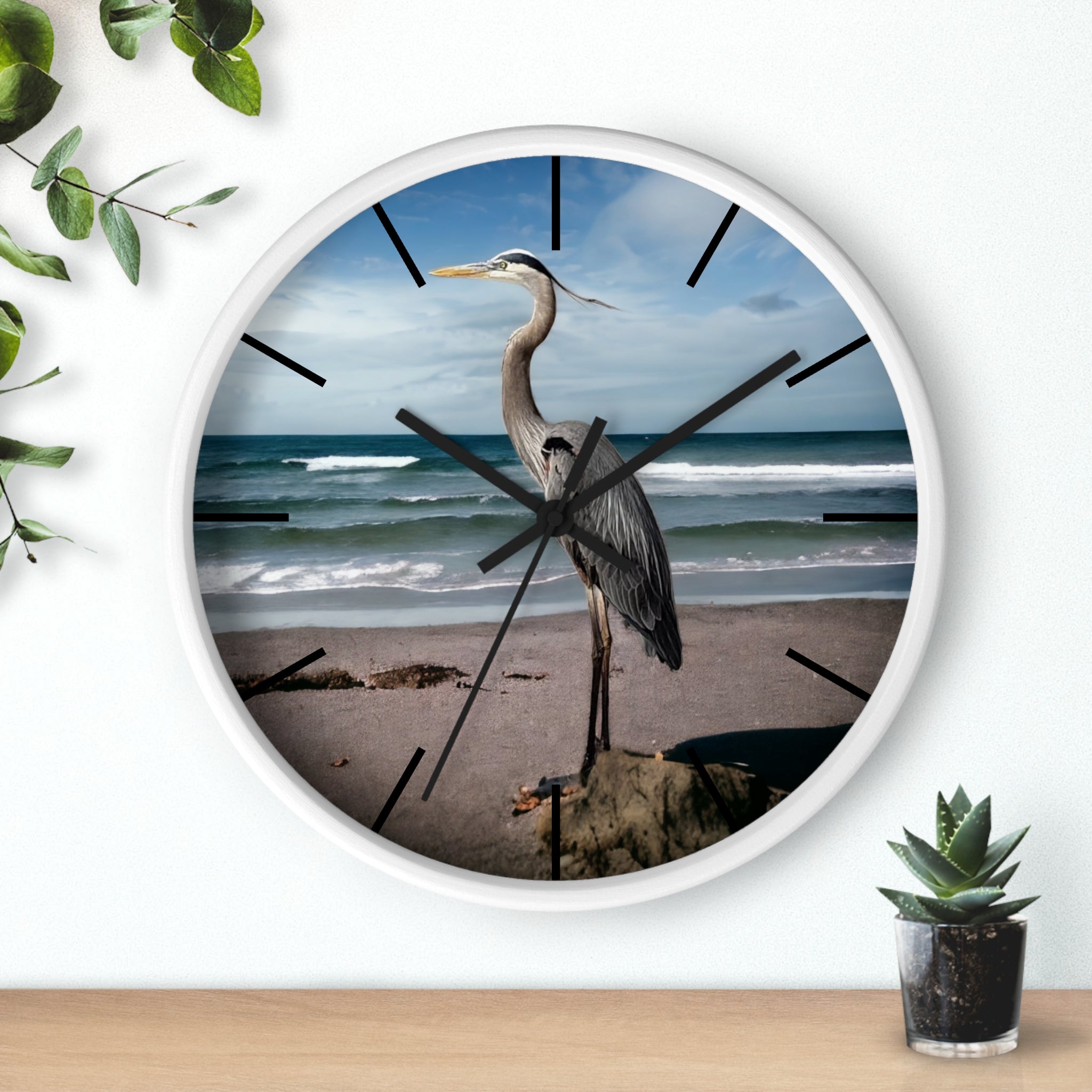 Stylish and functional, this wall clock features a radiant heron with a handmade resin on wood finish, ideal for coastal decor.