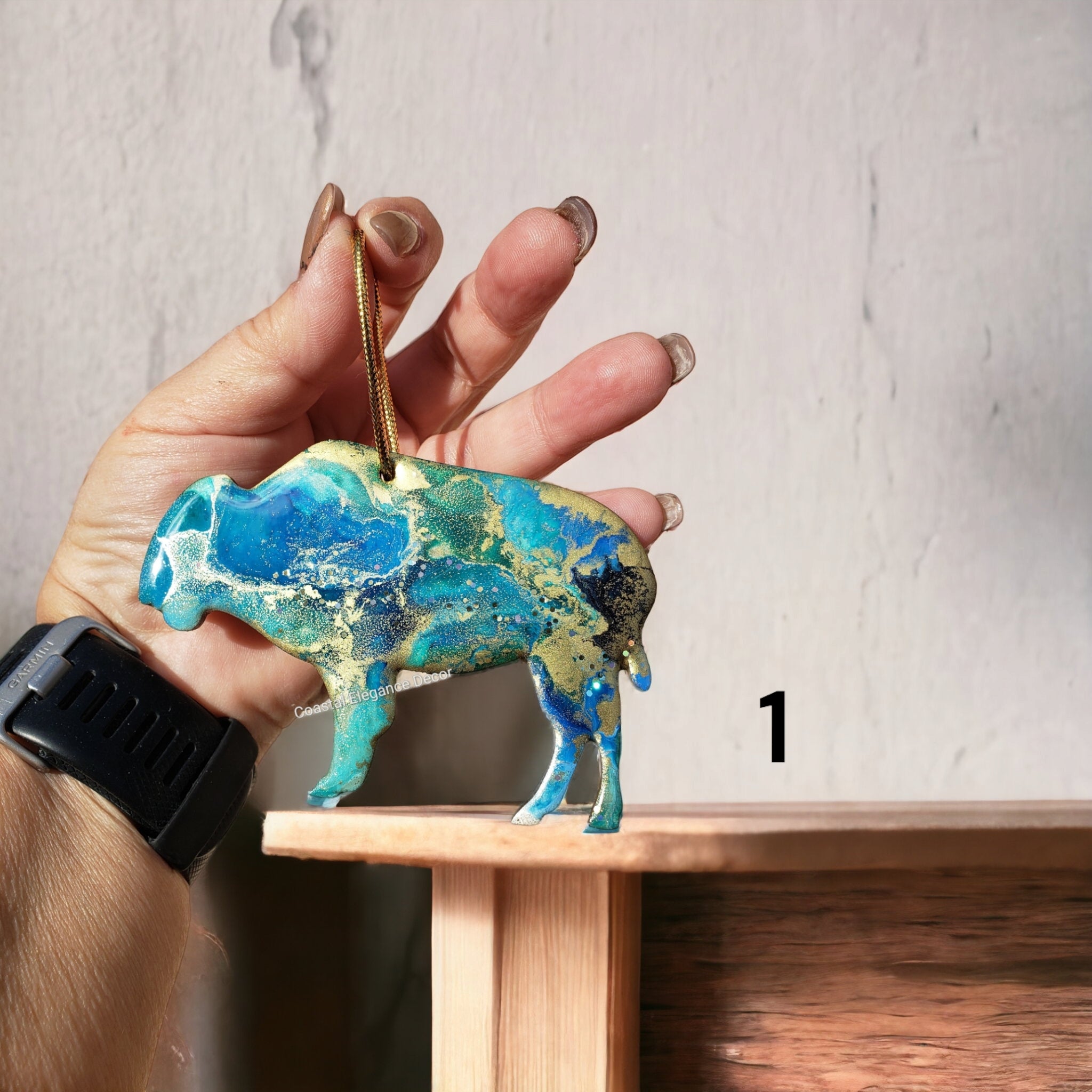 Beautifully crafted buffalo bison ornament made with handmade resin on wood, showcasing a rustic charm ideal for holiday decor.