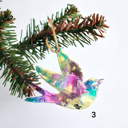 Beautiful peace dove ornament handcrafted from resin on wood, featuring vibrant colors and glitter accents, perfect for Christmas decoration.