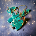 Charger l'image dans la visionneuse de la galerie, Delicate moose head ornament made from handmade resin on wood, highlighting its charming rustic design, ideal for gifting or home decoration.