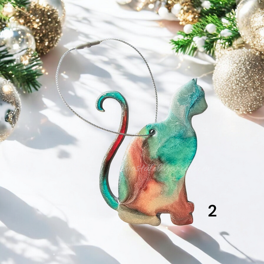 Close-up view of a handmade resin on wood kitty cat ornament showing vibrant colors and unique details, perfect for holiday decor.