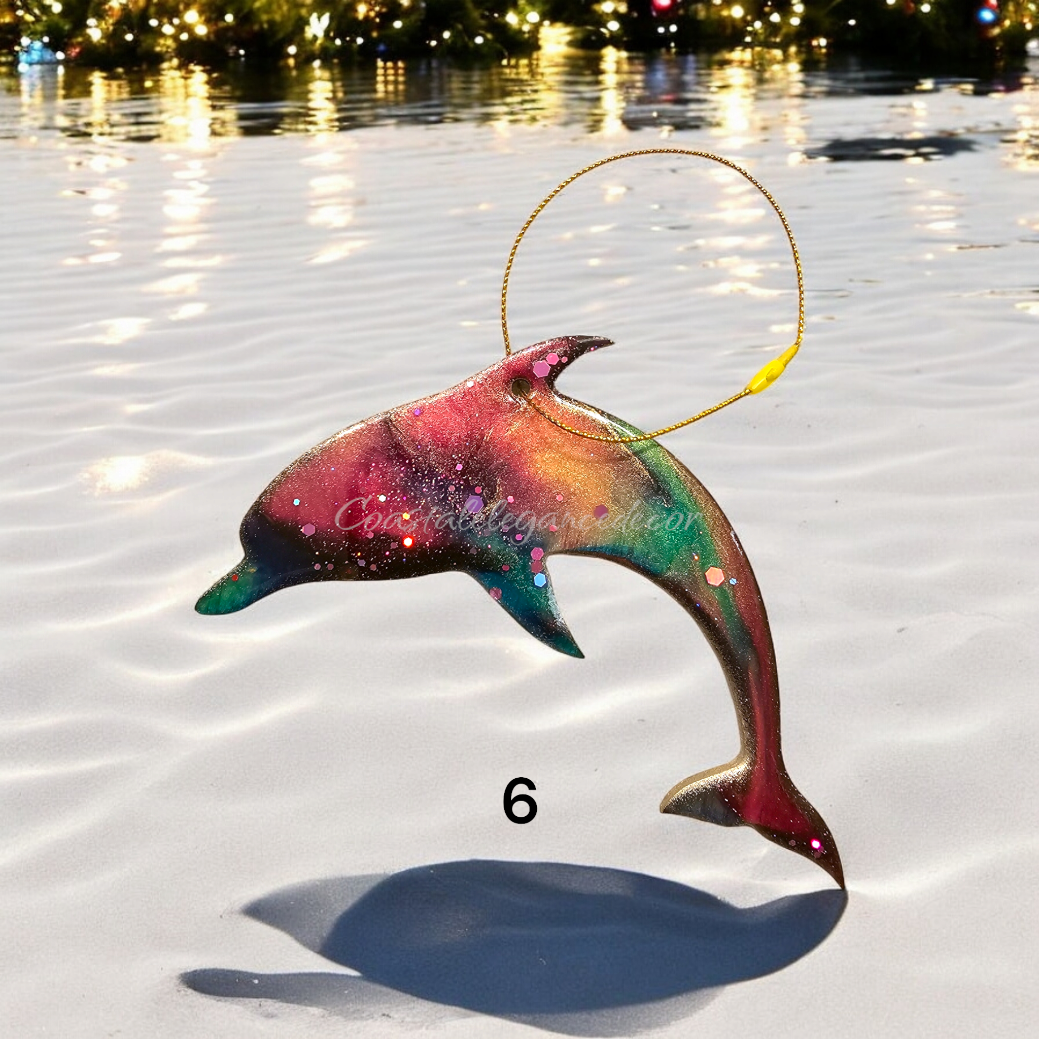 Sparkly dolphin ornament showcasing handmade resin on wood, perfect for bringing coastal flair to your Christmas tree.