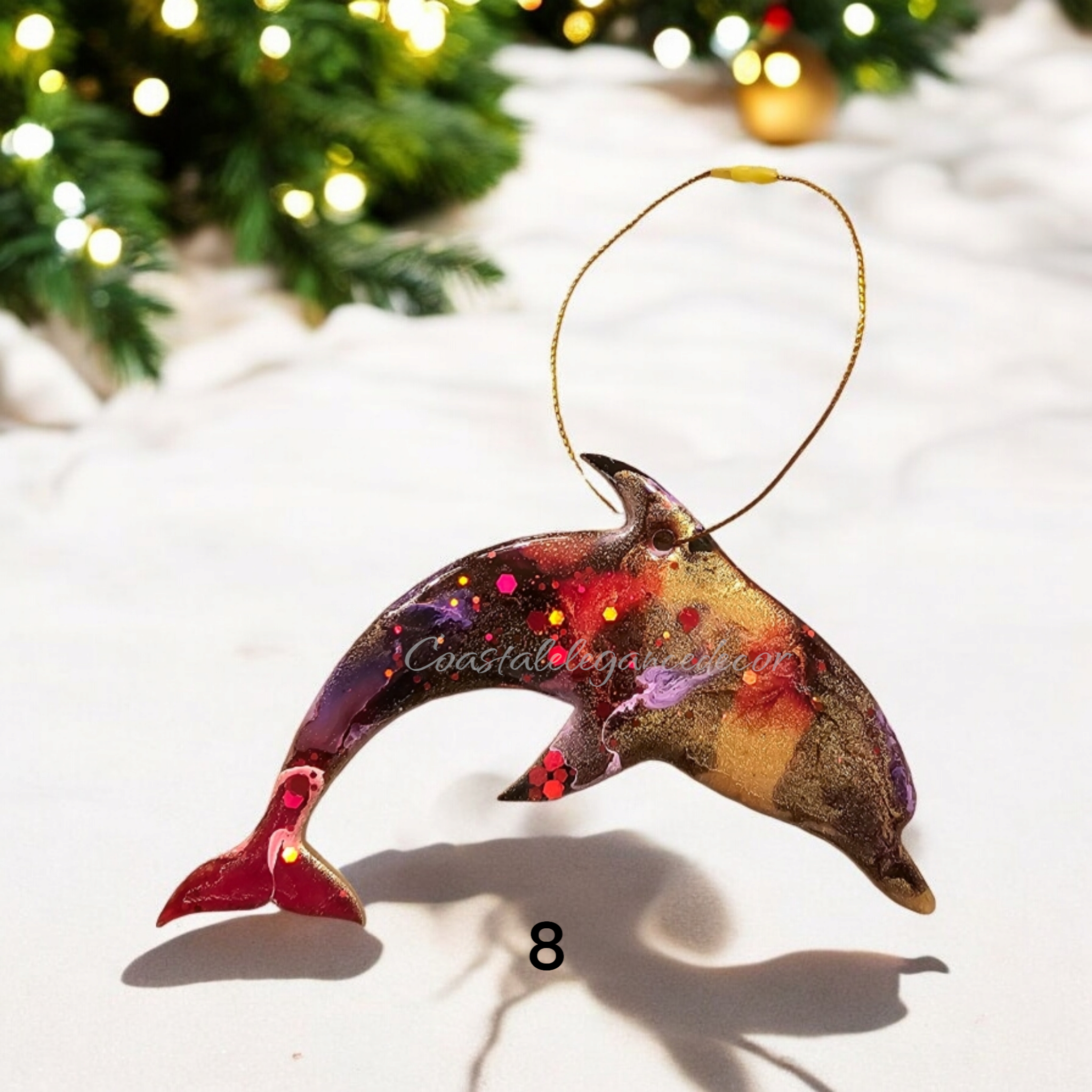 Colorful dolphin ornament handmade resin on wood, featuring vibrant pigments and sparkly accents, perfect for a beachy Christmas tree.