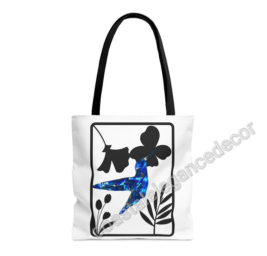 Close-up view of the Blue Hummingbird with Modern Black Flowers Tote Bag, showcasing its unique artwork of a blue hummingbird and black flower design on a minimalist white background.