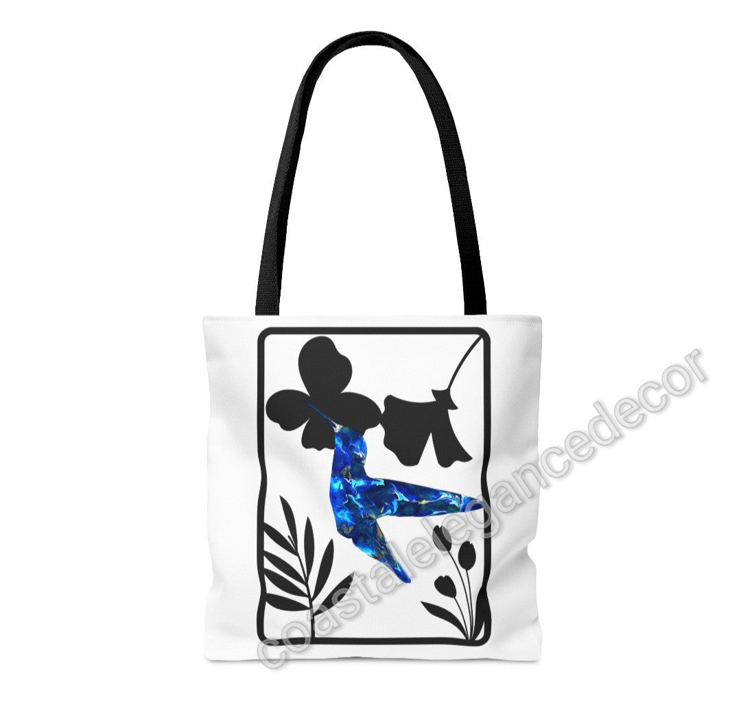 Blue Hummingbird with Modern Black Flowers Tote Bag featuring original art print. Available in two sizes, this stylish tote has a handmade resin hummingbird design on a minimalist white background surrounded by black floral elements, perfect for everyday use.