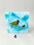 Charger l'image dans la visionneuse de la galerie, A square decorative cradle panel featuring two coastal mirror birds on a marbled light blue and white background, photographed on a light gray surface with a black number 4 below it.