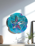 Load image into Gallery viewer, Colorful Beach Sand Dollar Wall Decoration Handmade by Coastal Elegance Decor, displayed in a bright indoor setting, emphasizing its unique design and eye-catching colors.