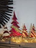 Charger l'image dans la visionneuse de la galerie, A set of handcrafted solid pine Christmas trees decorated with hand-poured swirling cranberry, fuchsia, and ivory fluid resin. The tall center tree features a diagonal band of crushed glass geode texturing with gold and glitter accents,