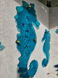 Load image into Gallery viewer, 1/4 inch thick transparent teal seahorse with intricate laser-etched coral details, designed to mimic the clarity of tropical ocean water.