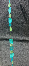 Load image into Gallery viewer, Beautiful Tide Pool Teals Capiz Shell Wind Chimes Strands measuring 72 inches, featuring vibrant teal, green, and turquoise shades, perfect for indoor or outdoor decoration.