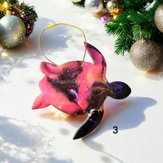A colorful handmade resin on wood sea turtle ornament with shiny metallic accents, perfect for holiday decor.