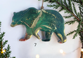 Charger l'image dans la visionneuse de la galerie, Handmade green resin bear Christmas ornament with white background and boughs