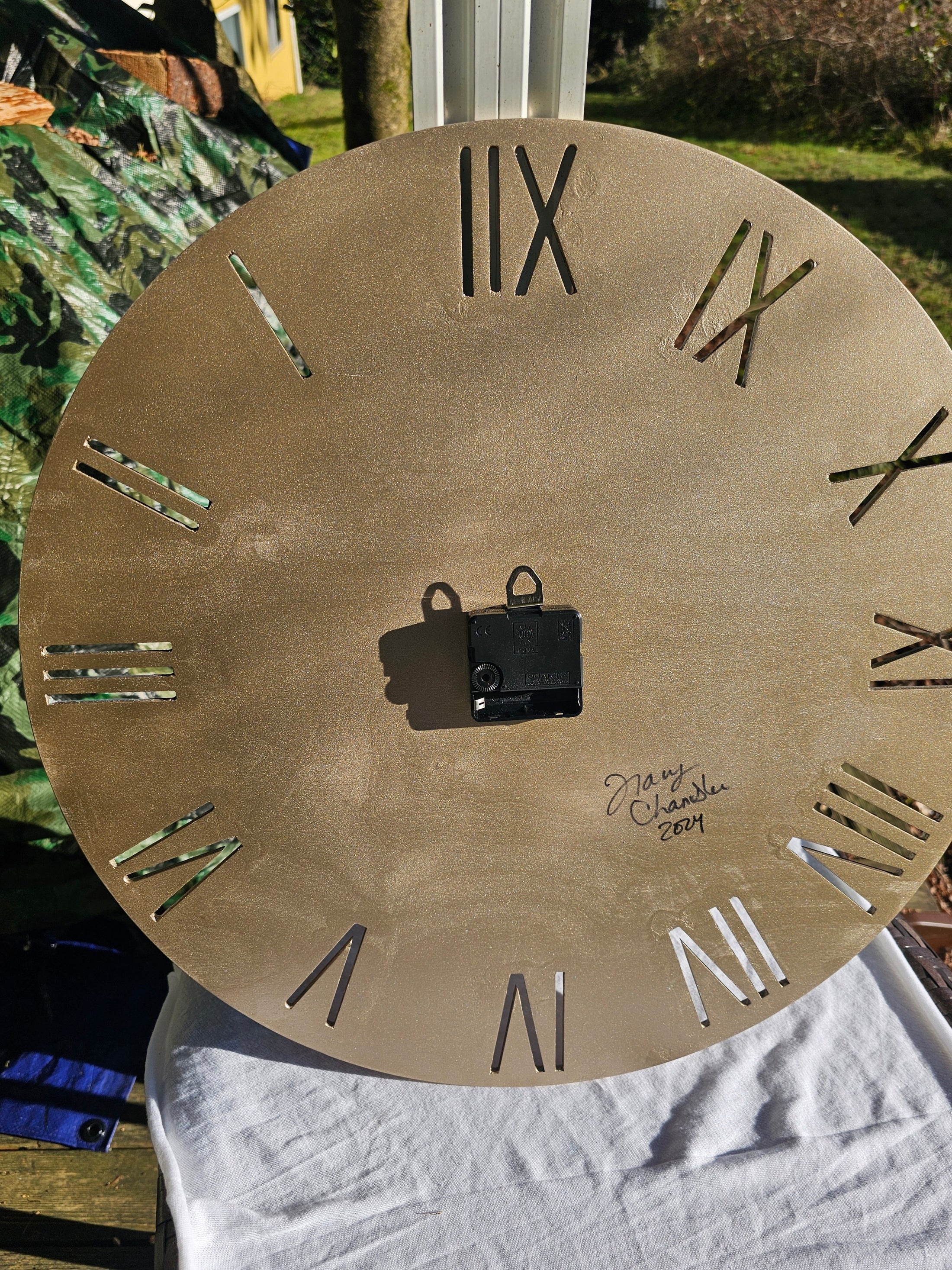 Back view of the 19.5 Inch Handmade Large Roman Numeral Teal Beach Ocean Waves Wall Clock showing the mechanism and signature, emphasizing the craftsmanship.