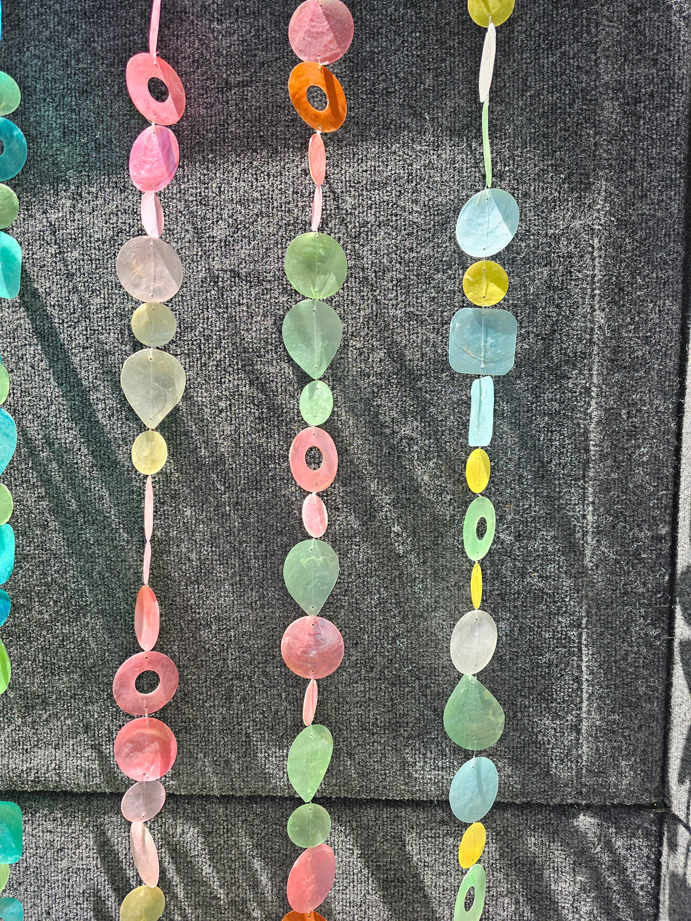 Capiz Shell Strands in Pinks and Greens 72 Inches Bougainvillea displaying colorful jingle oyster shells in teardrop and circle shapes, perfect for indoor or outdoor decor.