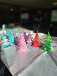 Charger l'image dans la visionneuse de la galerie, Handcrafted 5-Inch Christmas Trees with Colorful Resin and Wood for Holiday Tabletop Decor showcasing a vibrant display against a festive background.