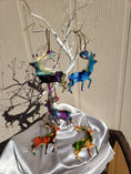 Charger l'image dans la visionneuse de la galerie, Handmade resin on wood standing reindeer ornament, showcasing unique fluid art design with colorful accents.