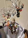 Charger l'image dans la visionneuse de la galerie, Beautifully crafted handmade resin on wood reindeer head ornament with metallic accents, ideal for holiday decor and gifts.