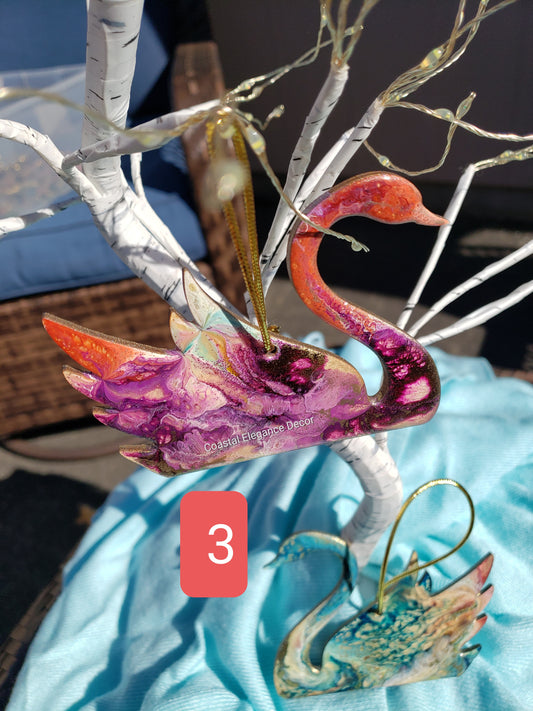 Beautiful handmade resin on wood swan ornament featuring vibrant colors and metallic accents, perfect for holiday decor.