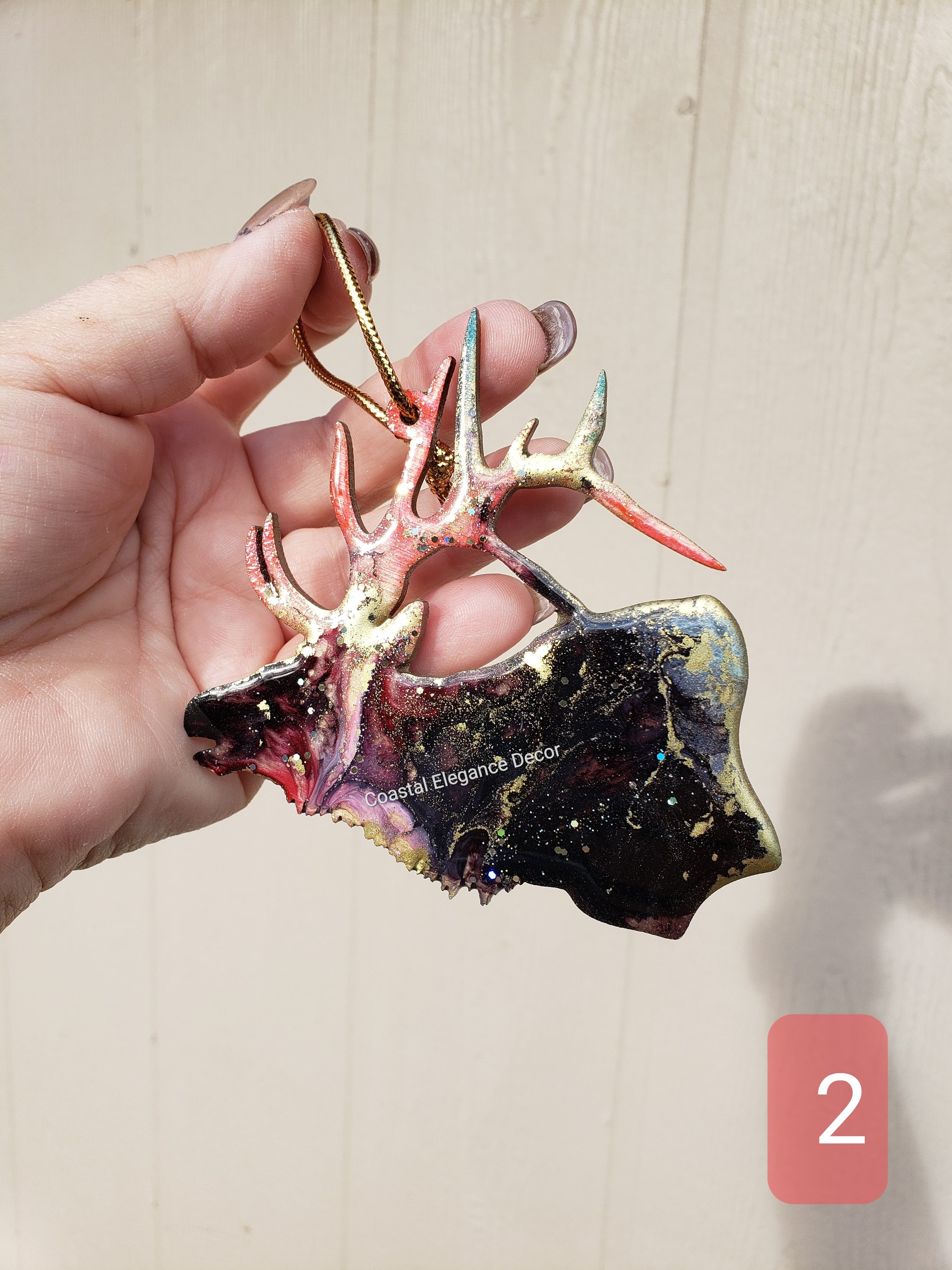 Stunning handmade resin on wood elk ornament with metallic accents, a one-of-a-kind piece for nature-themed home decoration.