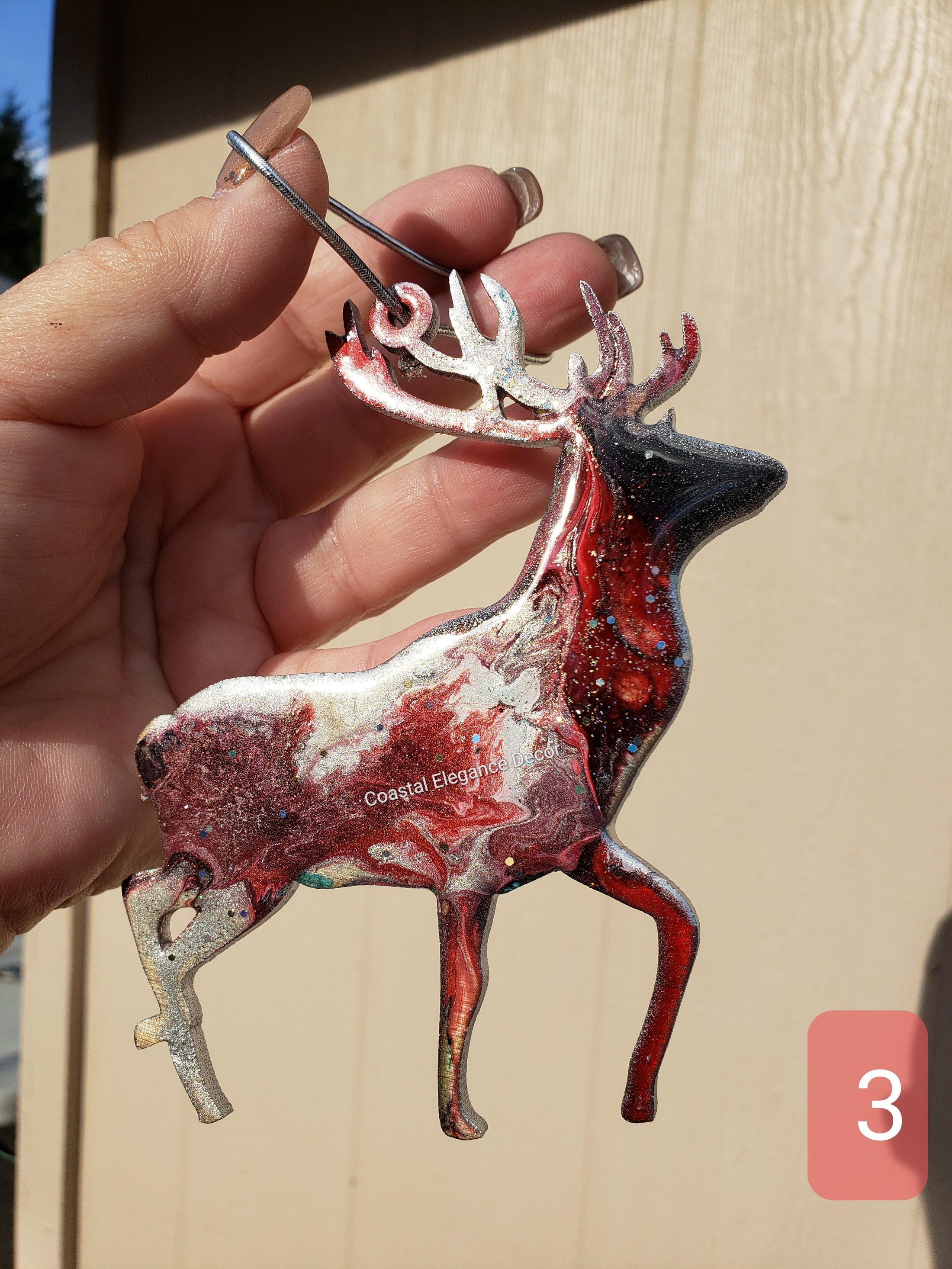 Beautifully crafted handmade resin on wood reindeer decoration, ideal gift for the holiday season with vibrant resin overlay.