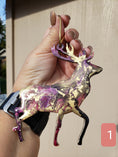 Charger l'image dans la visionneuse de la galerie, Decorative handmade resin on wood reindeer ornament, perfect for nature lovers, featuring metallic cord for hanging.