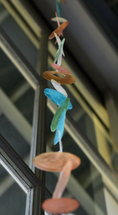 Load image into Gallery viewer, Capiz Shell Strands Patio Garden and Doorway Decoration featuring tropical flowers, showcasing a vibrant mix of turquoise blue, green, apricot, and ivory hues shimmering in the light. Perfect for adding a decorative touch to indoor and outdoor spaces.

