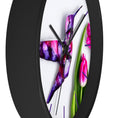 Load image into Gallery viewer, The side view of the Purple Print Art Hummingbird Wall Clock displaying the unique handcrafted resin artwork set against a backdrop of tulip flowers, crafted with handmade resin on wood.
