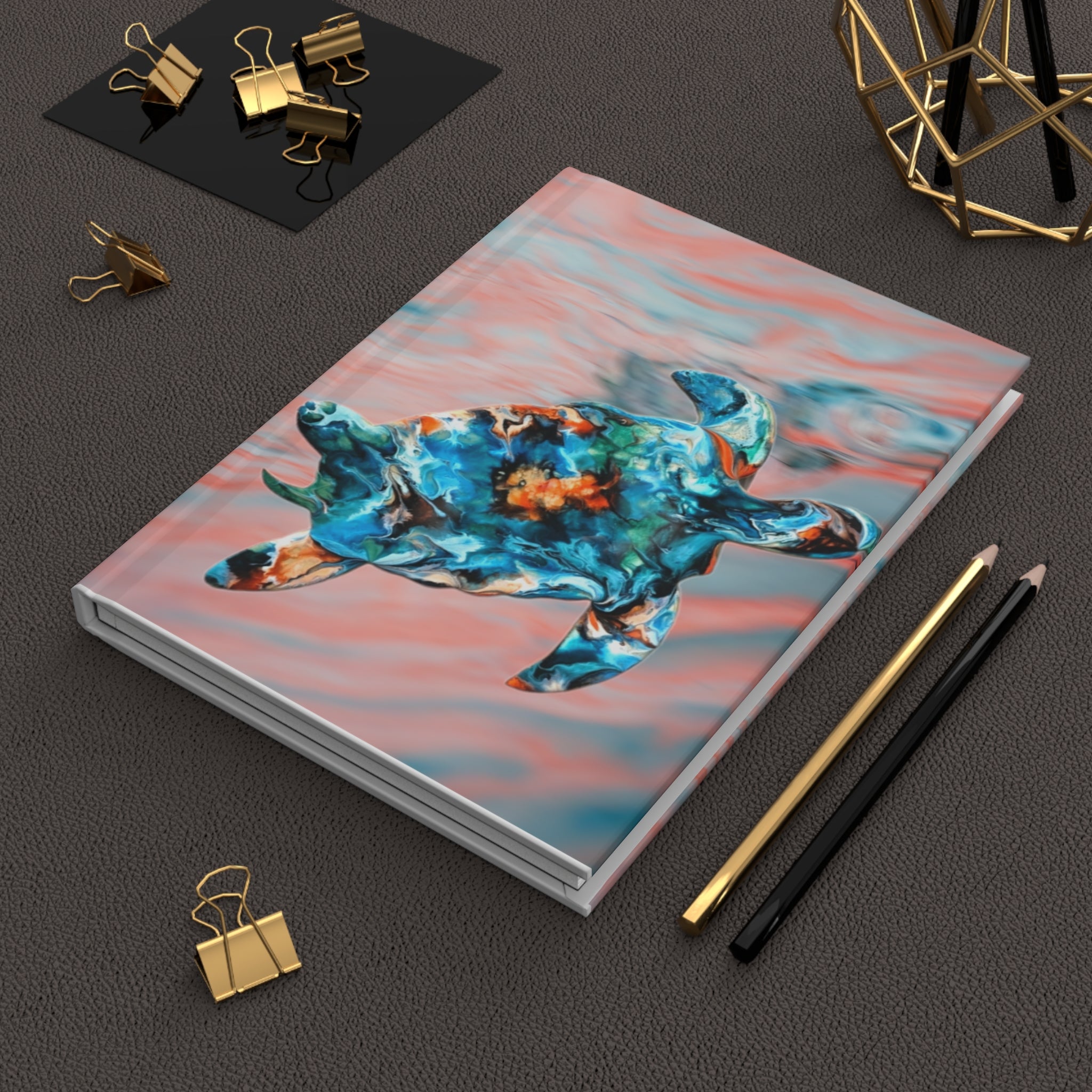 Close-up of a unique hardcover journal showcasing a coral and teal sea turtle print, presenting a handmade resin on wood style with intricate details.