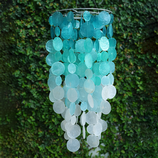 Large 24 inch turquoise ombre capiz shell chandelier with metal ring hanging against a green leaf background."