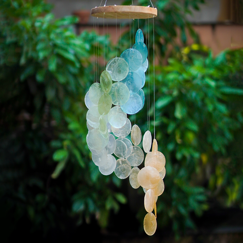 decorative spiral wind chimes in capiz shells turquoise, apricot and white for a stunning sunset coloration.