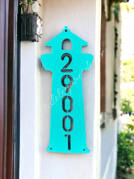 Customized lighthouse address sign featuring handmade resin on wood, showcasing colorful letters and numbers for a beach cottage decoration.