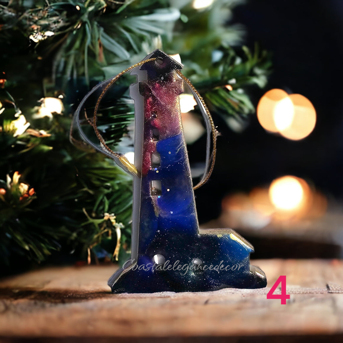 Colorful handmade resin on wood Christmas ornament featuring a coastal lighthouse with a keeper's house.