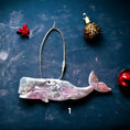 Charger l'image dans la visionneuse de la galerie, Handcrafted Ocean Sperm Whale Christmas Ornament - Colorful Resin & Wood Decor, measuring 5" x 2" with metallic cord, perfect for coastal holiday decor.
