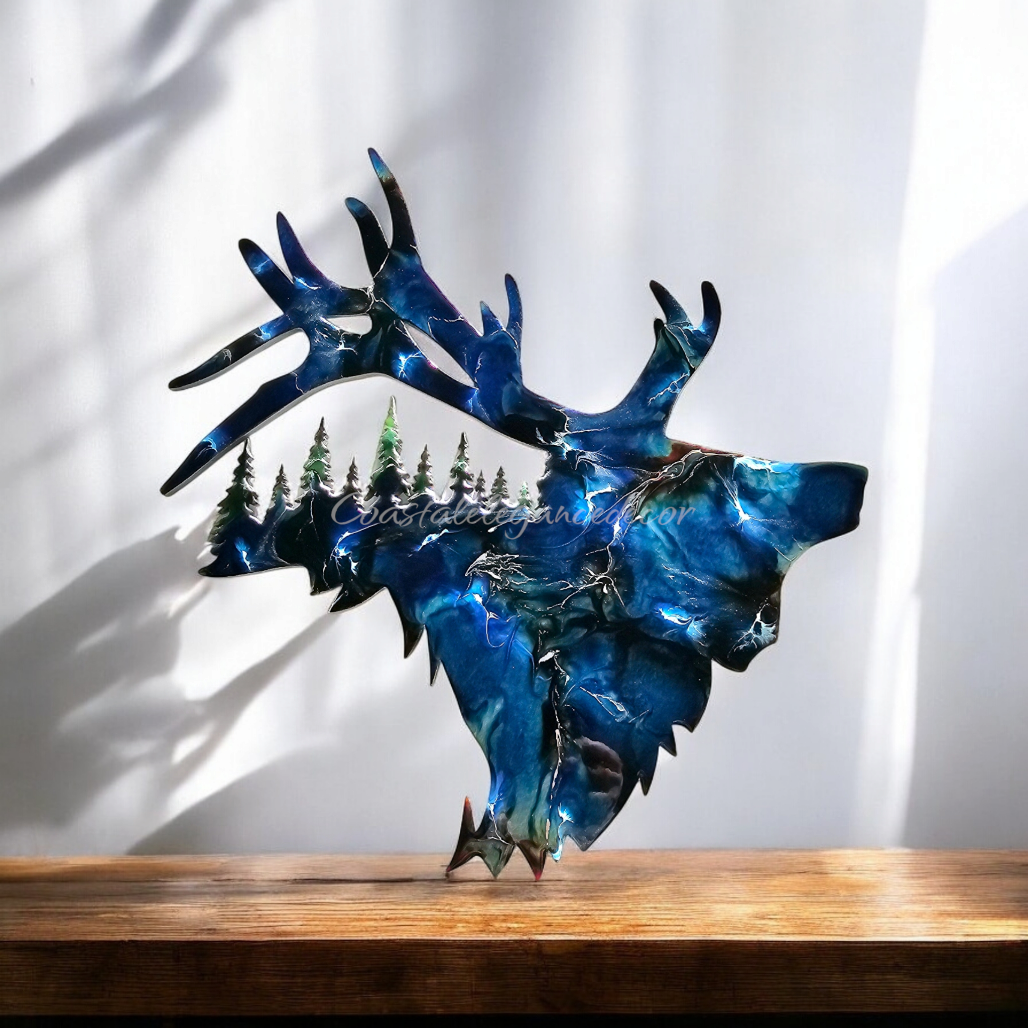 Beautifully crafted handmade resin on wood elk decoration, accented with royal blue and gold metallic details.