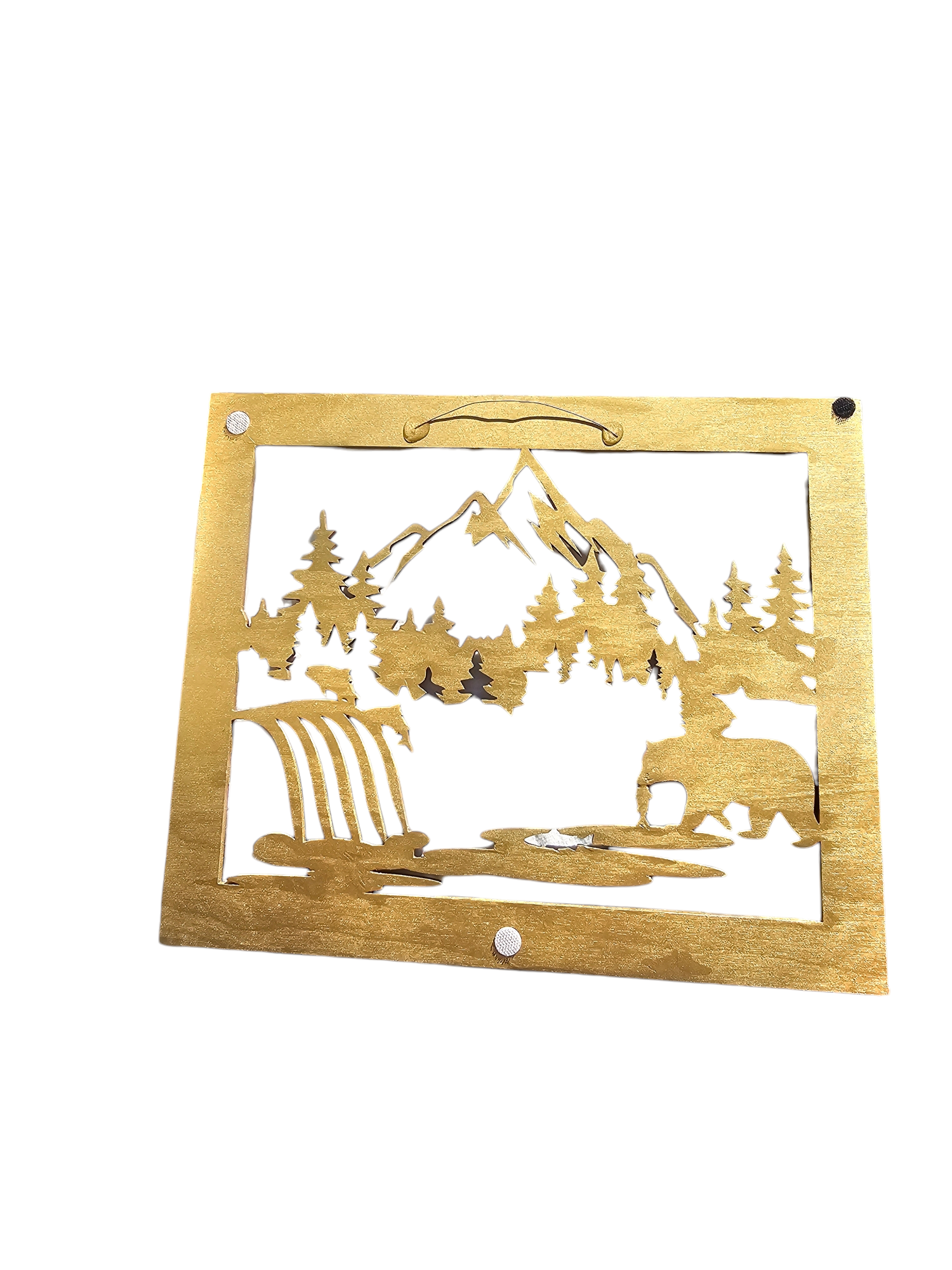 Handmade wall decoration depicting a bear at waterfall with salmon and mountain, made of resin on wood, featuring a sleek gold finish that enhances any indoor decor. Gold back with wire hanger 