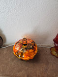 Charger l'image dans la visionneuse de la galerie, Coastal Elegance Decor handcrafted glass pumpkin dish with amber, orange, and obsidian ink-style swirls on a table
