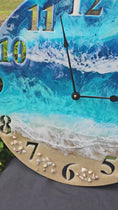 Load and play video in Gallery viewer, Ocean Blues 19.5 Inch Round Wall Clock With Real Beach Sand, Seashells, and Resin Waves
