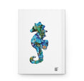 Load image into Gallery viewer, Beautiful Coastal Seahorse Print Hardcover Journal Lined Paper featuring a striking seahorse cutout on a matte background, perfect for note-taking and sketches.
