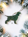 Load image into Gallery viewer, Green and gold handmade resin springer spaniel dog Christmas ornament in a white background with to j Christmas lights 
