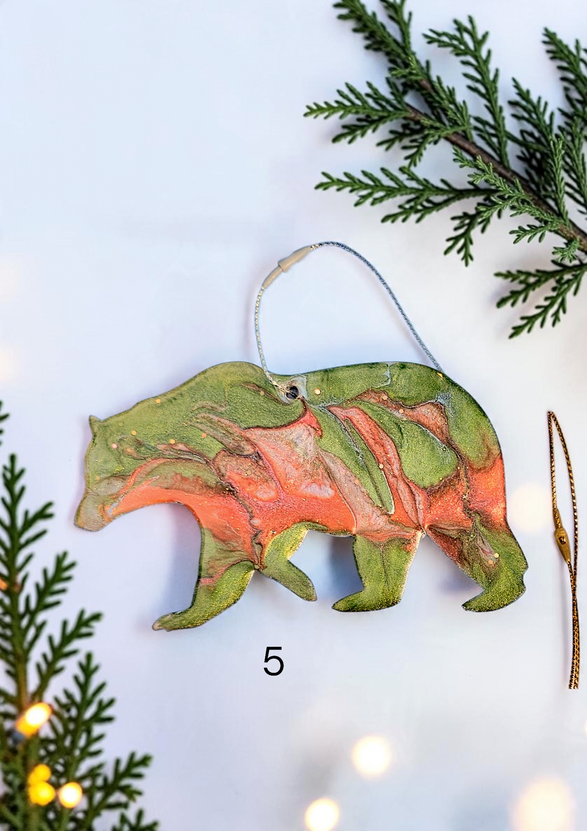 Handmade green resin bear Christmas ornament with white background and boughs 