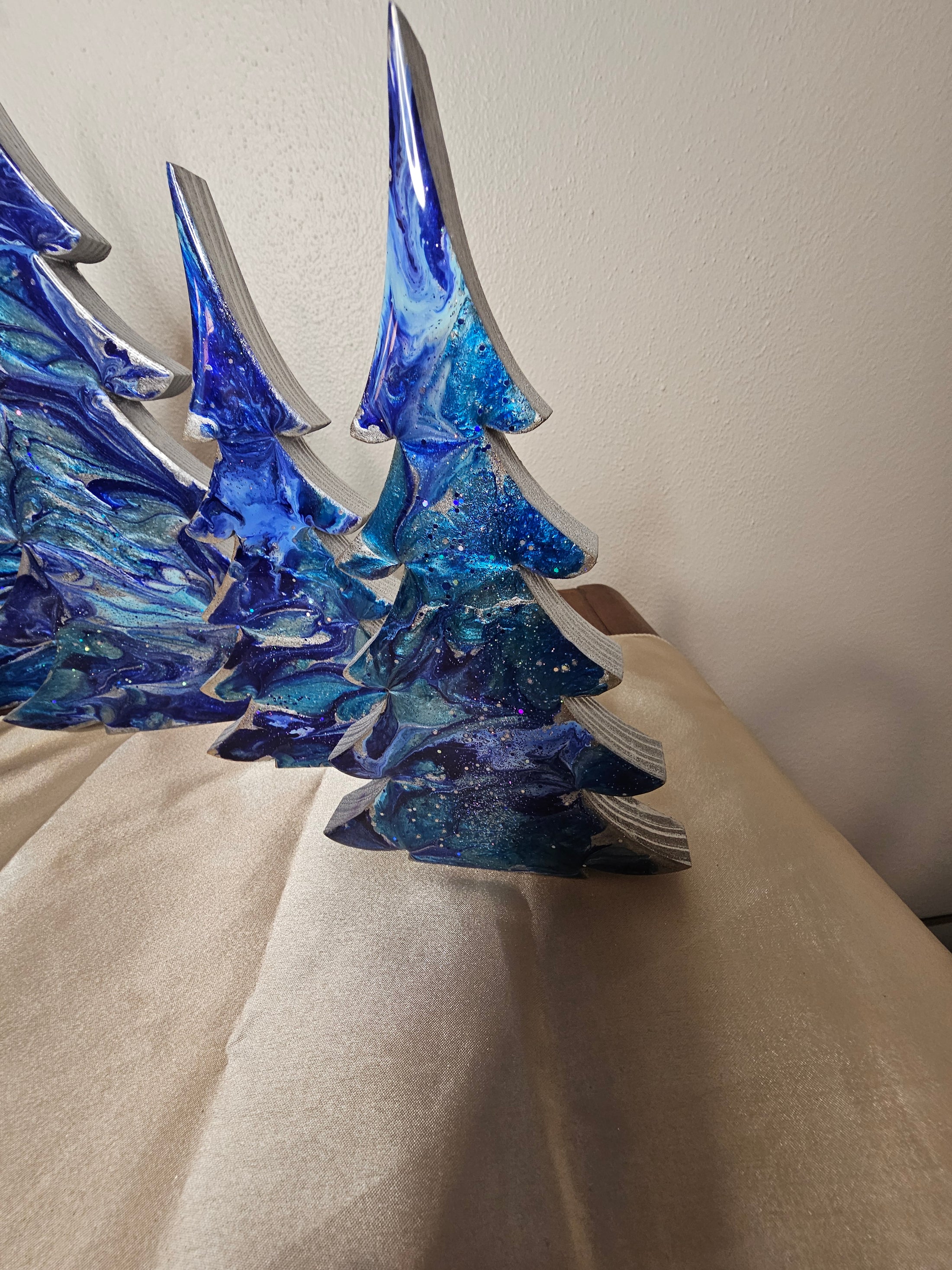 Unique Handmade Cobalt and Silvery Blue Resin Wood Christmas Trees showing patterns and swirls, perfect for Holiday Mantelpiece by Coastal Elegance Decor.