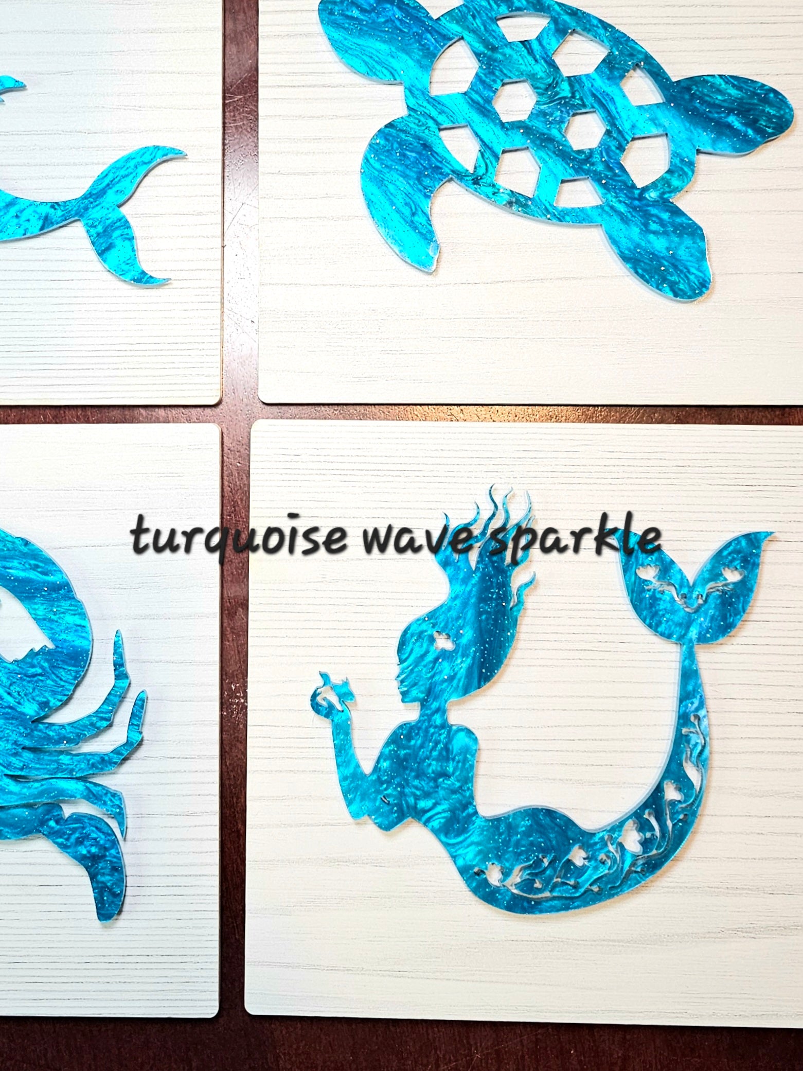 Set of turquoise wave and mermaid designs on whitewashed wood with 'turquoise wave sparkle' text.