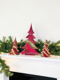 Charger l'image dans la visionneuse de la galerie, A set of handcrafted solid pine Christmas trees decorated with hand-poured swirling cranberry, fuchsia, and ivory fluid resin. The tall center tree features a diagonal band of crushed glass geode texturing with gold and glitter accents
