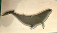 Load image into Gallery viewer, Close-up of a laser-engraved humpback whale silhouette in translucent smoke-colored acrylic, showing the polished 1/4 inch thick edges and intricate detail
