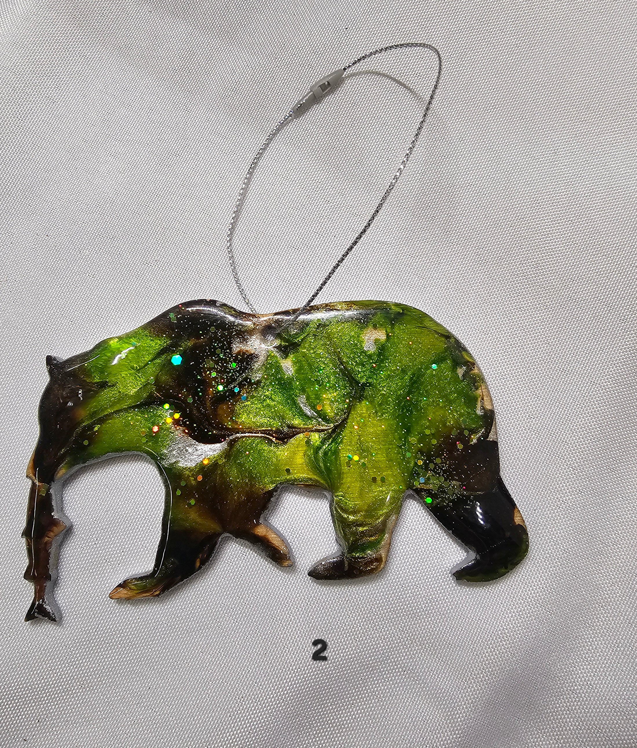 Close-up of the Handmade Grizzly Bear Christmas Ornament with Salmon showcasing its colorful resin overlay and metallic accents.