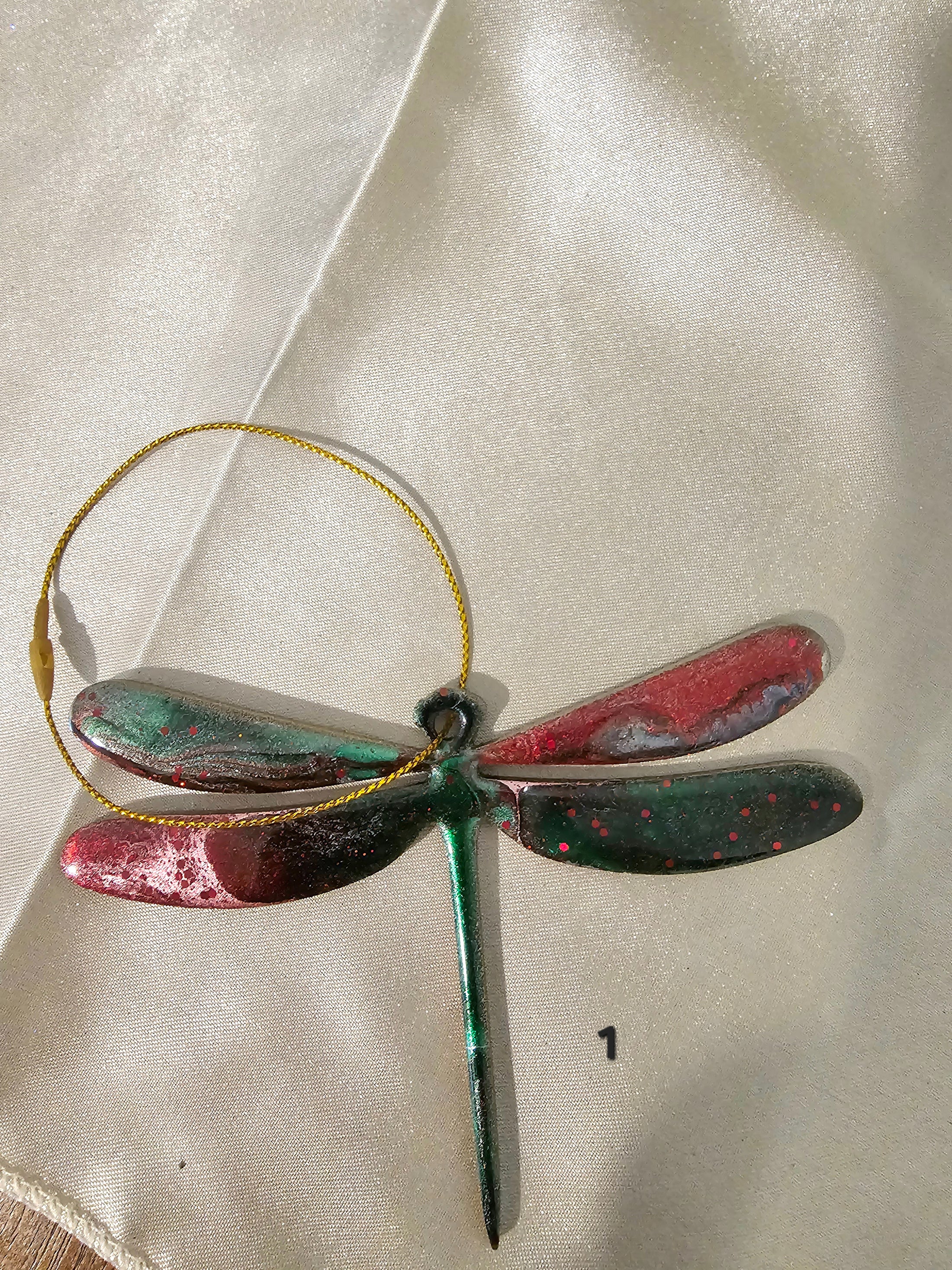 Close-up of a Handmade Nature Dragonfly Christmas Tree Keepsake Ornament featuring glitter and metallic accents.